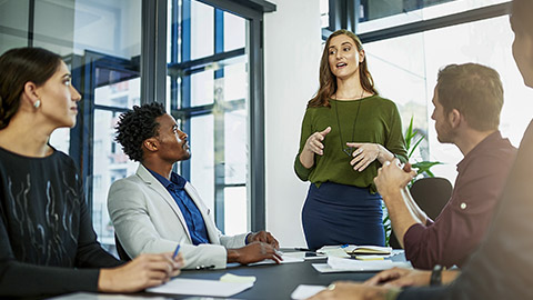 a businesswoman delivering a presentation to her coworkers.