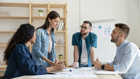 Woman employee communicating with colleagues