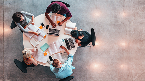 Top view of group of students sitting together at table