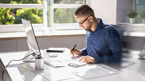 Accountant Using E Invoice Software At Computer In Office