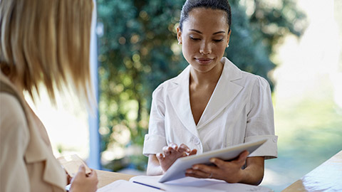 a female receptionist talking to a client