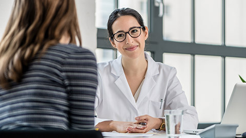 physician listening to her patient during consultation