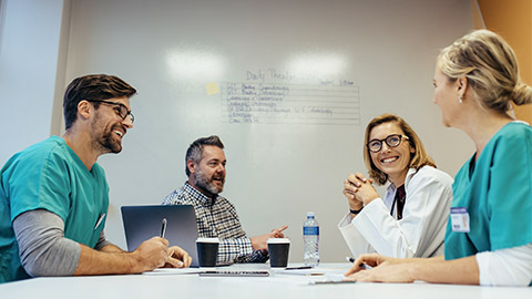 Happy medical team having a meeting in conference room in hospital