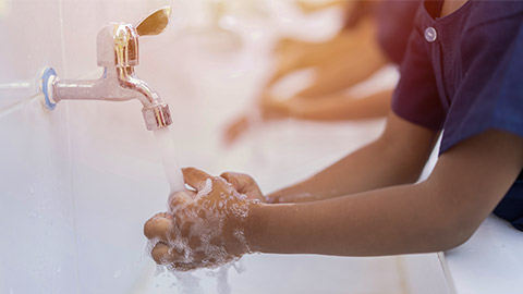 close up hands of children or Pupils At preschool Washing hands with soap under the faucet