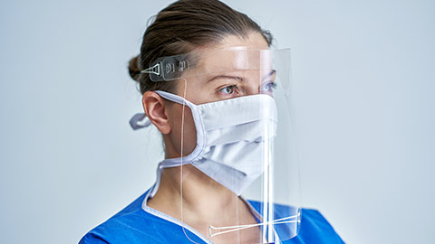 female medical doctor wearing protective mask and face shield