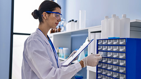 woman scientist writing report working at laboratory