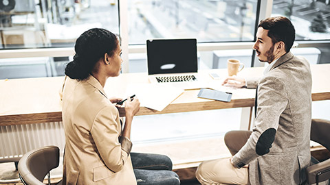 Woman talking to a man formally