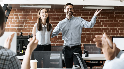 Team congratulates a coworker, group applauds