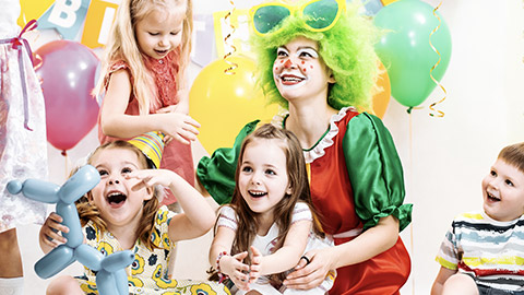 Jolly children with female clown