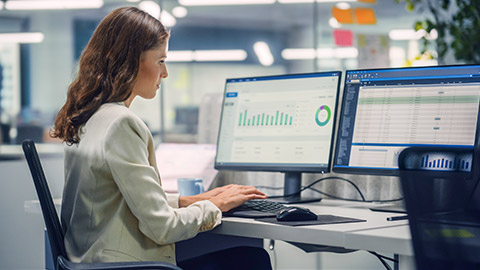 Businesswoman Using Desktop Computer in Modern Office