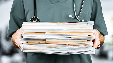 Doctor holding medical files