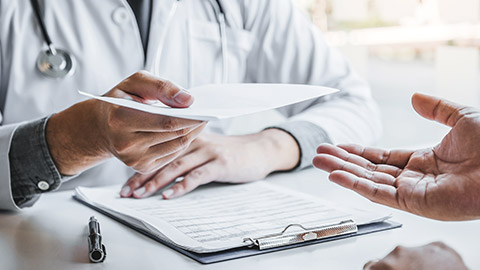 Doctor handing diagnostic examination to a patient