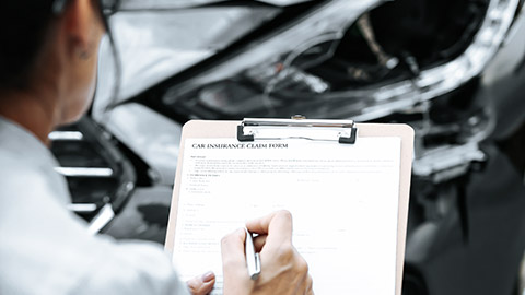 Woman filling up car insurance form