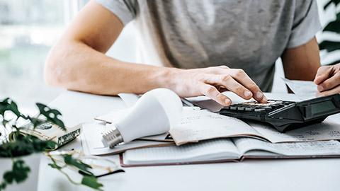 Man counts bill on calculator