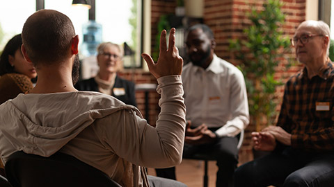 Man with addiction sharing health problems with group at aa meeting