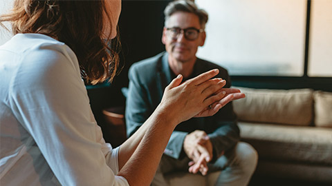 Two business people discussing in office lounge