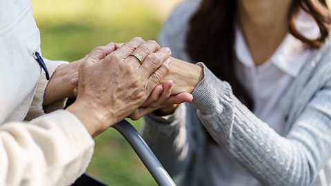 Family relationship Asian senior woman in wheelchair with happy daughter holding caregiver