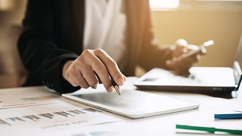 businessman working on project for analyzing company financial report balance statement with documents graphics at modern office space