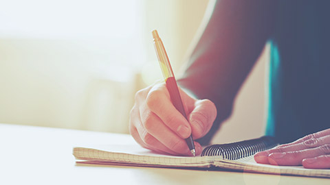 A close view of a person writing