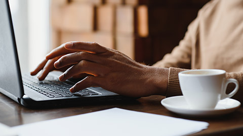 A close view of a person typing on a laptop