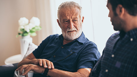 A worker talks to an elderly client