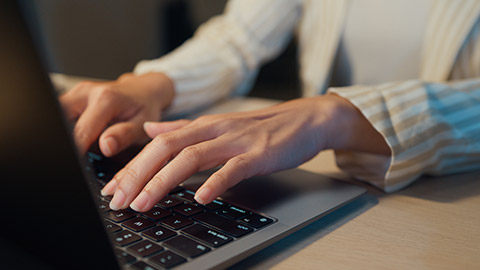 A person typing on a keyboard