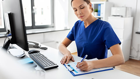 A person logging information on a clipboard