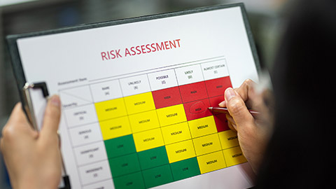 A person filling in risk assessment paperwork