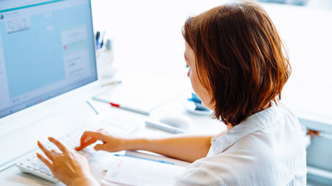 A person typing on a keyboard