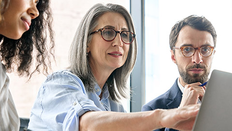 A group of people talking in an office