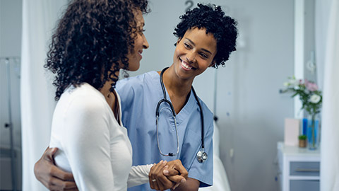 female doctor helping female patient to walk in the ward at hospital