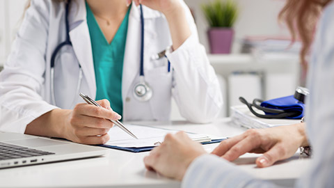 doctor consulting patient and sitting at office