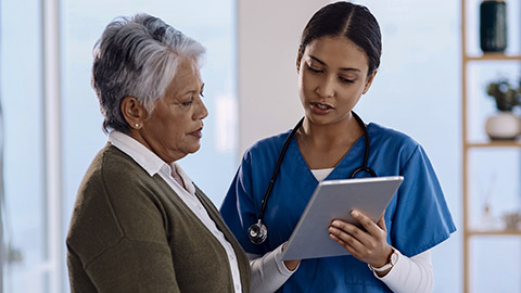 young doctor using a digital tablet during a consultation with a senior woman