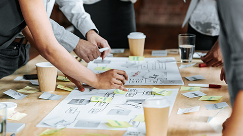 Brainstorming session, close-up hands with post-it notes