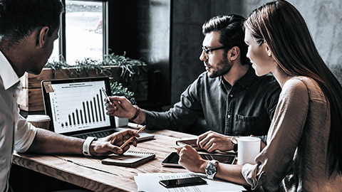 Group of professionals analysing data on the computer