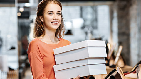 Holding boxes of shoes