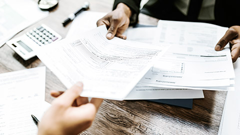 A man giving a paper to a client