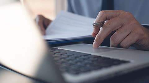 Businessman hand touching on touchpad, typing on laptop computer keyboard