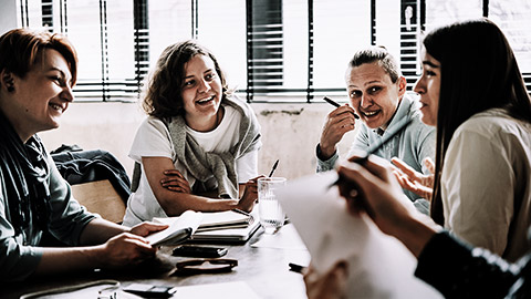 A group of people talking to each other