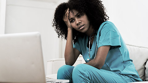 A female nurse distraught about reporting an inappropriate inceident she witnessed