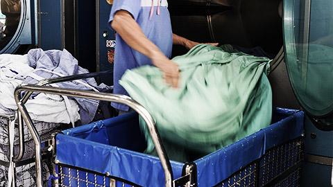 A person managing hospital linen