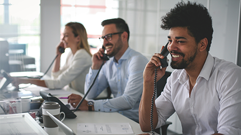 People in operations center talking on Landline phone