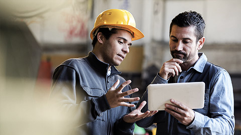 A worker advicing an executive about work space safety from the trenches