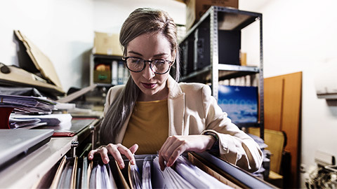 A person sifting through files and records