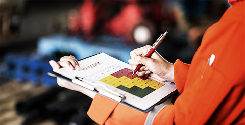 A safety officer checking of their risk managment matrix