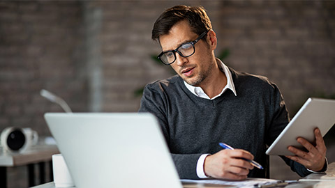 Multi-tasking businessman working in the office