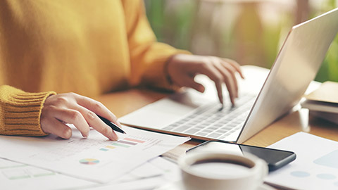 Young serious accountant woman checking paperwork