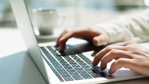 A close view of a person typing on a laptop