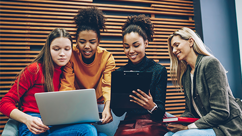 Positive young multiracial women on a computer