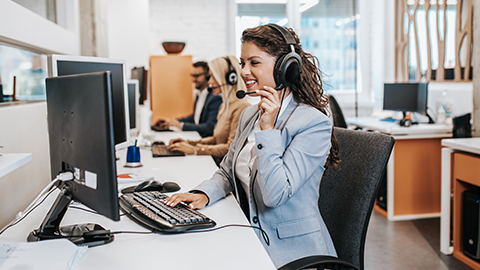 Team of call center employees working together on office.